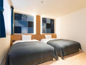 Postel nebo postele na pokoji v ubytování Nagi Kurashiki Hotel&Lounge