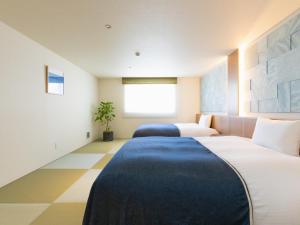 Postel nebo postele na pokoji v ubytování Nagi Kurashiki Hotel&Lounge