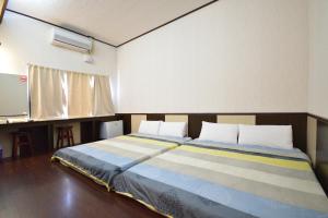 Postel nebo postele na pokoji v ubytování Luyi Ludao B&B