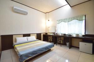 Postel nebo postele na pokoji v ubytování Luyi Ludao B&B