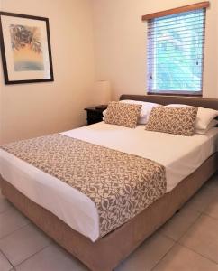 A bed or beds in a room at Coral Sea Villas