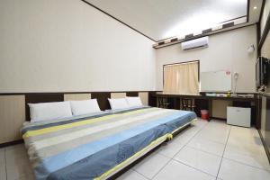 Postel nebo postele na pokoji v ubytování Luyi Ludao B&B