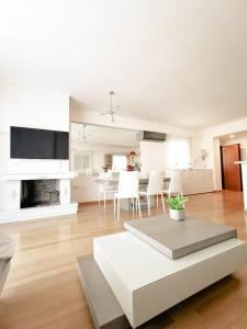 a living room with a table and a dining room at New Luxury Apartment in Glyfada with pool in Athens