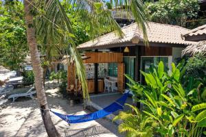 a house with a hammock in front of it at Cookies Salad Resort in Salad Beach