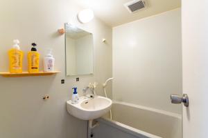 a bathroom with a sink and a shower at Type B Room 63平米 -ウル エスポワール石垣- in Ishigaki Island