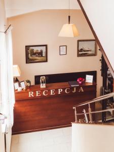 a reception room with a reception desk in a building at Hotel Osjann in Biała Podlaska