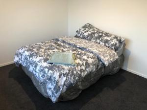 a bed with a pillow and a book on it at The Drydock in Stratford