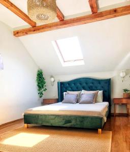 a bedroom with a bed and a skylight at Vila Aldor in Bran