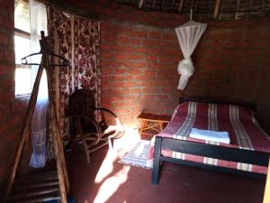 a bedroom with a bed and a brick wall at Mailua Retreat in Mailua