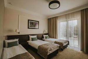 Postel nebo postele na pokoji v ubytování Hotel Toscania