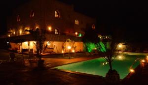 a swimming pool in front of a building at night at Dar Essaada in Essaouira