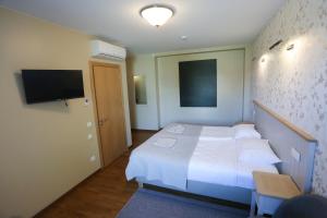 Postel nebo postele na pokoji v ubytování Hotel Jonapolis