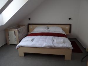 a bedroom with a large bed with white and red sheets at Relax Center Olimian in Podčetrtek