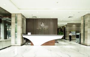 a woman standing in the lobby of a building at HongKong Tower managed by Lily Home in Hanoi