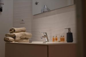 a bathroom counter with a sink with towels on it at L'Arche de Porquerolles in Porquerolles +37 photos