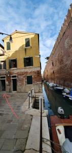 a boat is docked in a canal next to a building at Ca' Venice Canal View in Venice