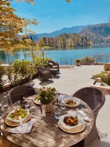 
a table set up for a picnic on a beach at Adora Luxury Hotel in Bled
