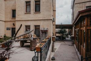 a view of a building with a truck in a courtyard at Royal Stone Houses - Goreme in Göreme