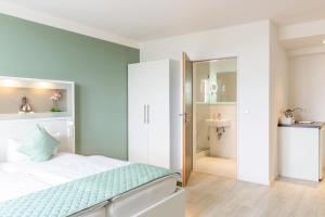 a bedroom with a bed and a bathroom at bedpark Stellingen in Hamburg