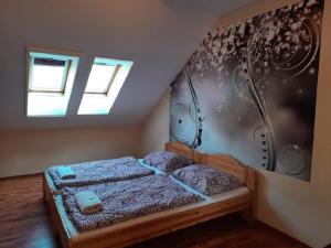 A bed or beds in a room at Ponty-Poronty Vendégház Még 30 kép