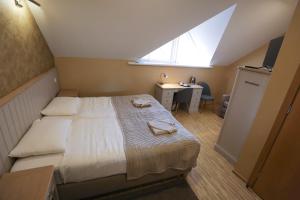 Postel nebo postele na pokoji v ubytování Hotel Jonapolis