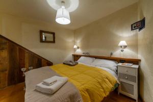 1 dormitorio con 1 cama grande con manta amarilla en Casa Aline, en La Salle