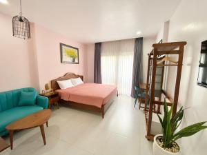 a bedroom with a bed and a chair and a ladder at Mai Home - Apartment & Homestay in Ho Chi Minh City