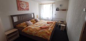 a small bedroom with a bed and a window at Penzion Tomy Pihlov in Horní Planá