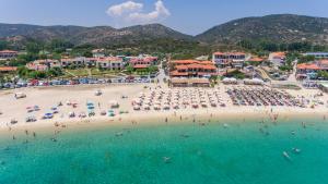 an aerial view of a beach with people in the water at Lofos Kalamitsi in Kalamitsi