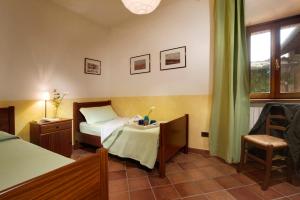 A bed or beds in a room at Agriturismo Le Macie