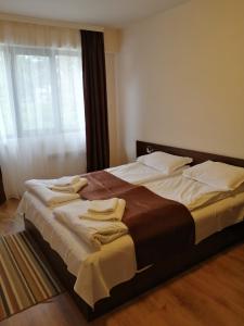 duże łóżko w pokoju z oknem w obiekcie апартаменти Tryavna lake w mieście Trjawna