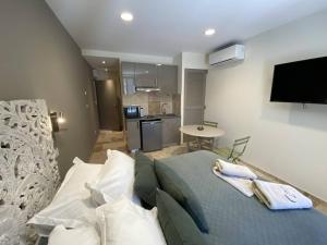 a living room with a couch and a kitchen at L'Arche de Porquerolles in Porquerolles