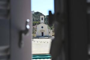 a view of a church through a window at L'Arche de Porquerolles in Porquerolles