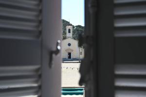a view of a church from a window at L'Arche de Porquerolles in Porquerolles