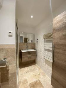 a bathroom with a sink and a mirror at L'Arche de Porquerolles in Porquerolles