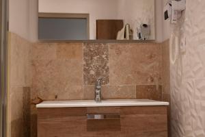 a bathroom with a sink and a mirror at L'Arche de Porquerolles in Porquerolles