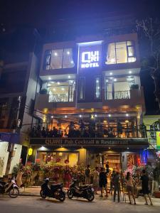 a group of people standing outside of a building at Quiri Hotel in Cat Ba