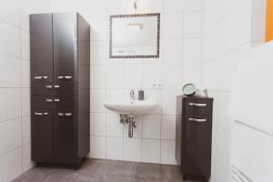 bagno bianco con lavandino e specchio di Lesachtalerhof a Liesing