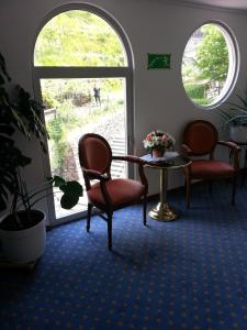 a room with two chairs and a table and a window at Hotel Colibrì in Lugano