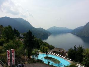 a view of a lake with a swimming pool at Hotel Colibrì in Lugano