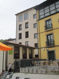 a man walking in front of a building at La Refierta in Cangas del Narcea