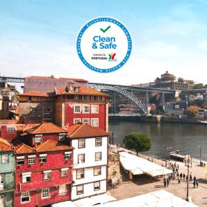 
a large building with a boat in the water at Ribeira do Porto Hotel in Porto
