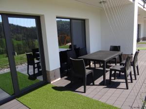 a table and chairs on a patio with a view at Relax Center Olimian in Podčetrtek
