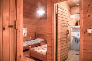 a sauna with two beds and a sink at Ranch Kaja & Grom in Vojnik