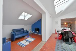 a living room with a blue couch and a table at Place Carnot 1900: Coeur de Ville in Avignon