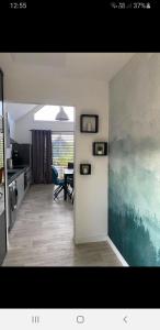 a living room with a kitchen and a dining room at la douce Cahute in Fresnicourt-le-Dolmen