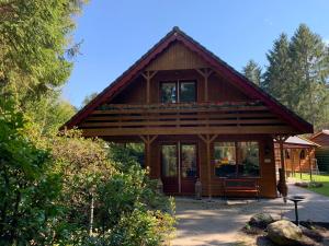 a log cabin with a large window on it at 't Holten Huus - Puur genieten in het bos. in Norg