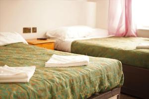 A bed or beds in a room at Plaza Hotel 