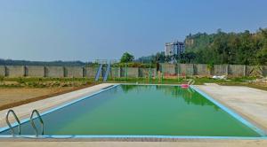an empty swimming pool in a park at Marina Beach Villas Resort in Cox's Bazar