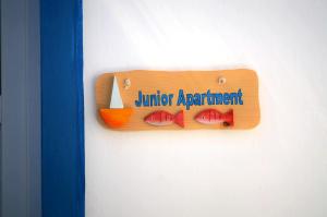 a wooden sign on a wall with fruit on it at Summer Residence in Provatas